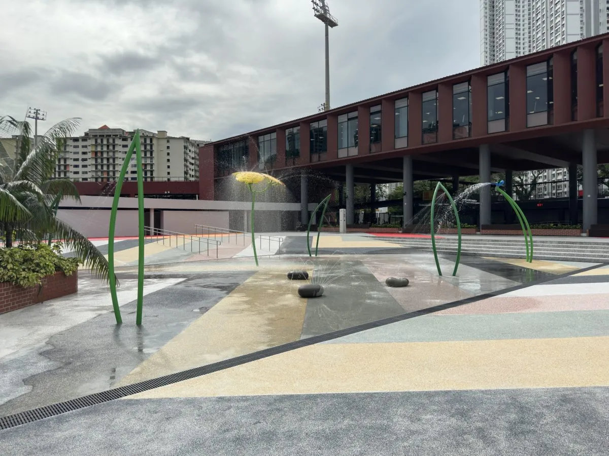 Colourful water play area with flower-shaped fountains for children at Delta Swimming Complex